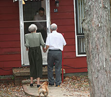 Photo of people in front of a house. Link to Gifts of Real Estate.
